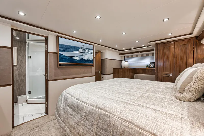 Lucky Wave Yacht Photos Pics Luxurious bedroom interior of 2021 Viking 80 Convertible yacht with modern decor and ensuite bathroom.