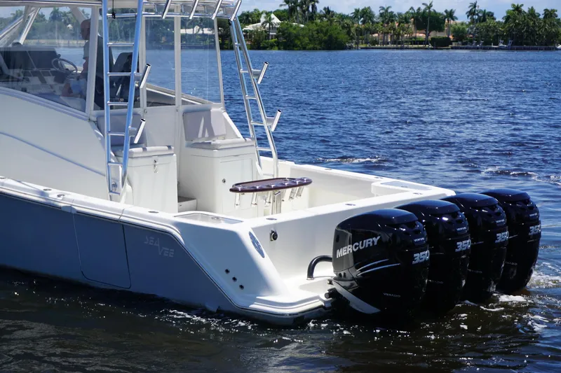  Yacht Photos Pics 2015 SeaVee 430 FA boat with four Mercury engines on a calm waterway.