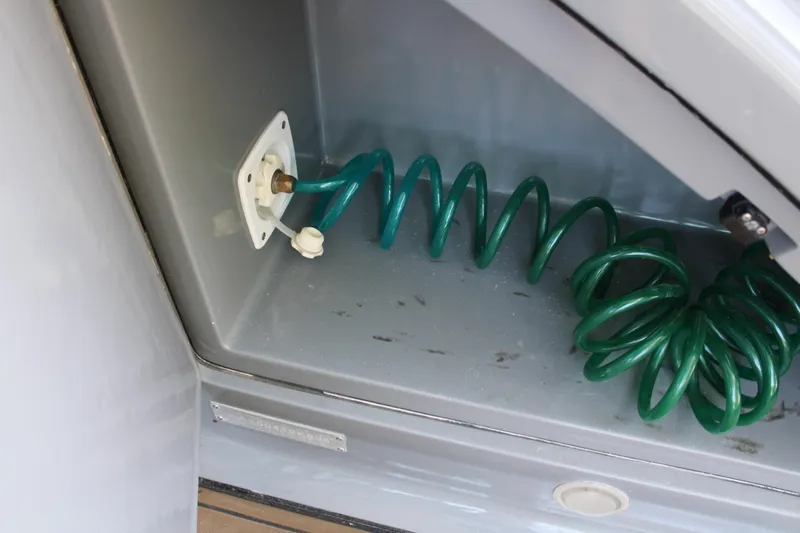  Yacht Photos Pics Coiled green hose in storage compartment of 2006 Azimut 50 yacht.