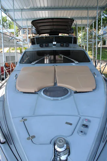  Yacht Photos Pics 2006 Azimut 50 yacht with sunbathing deck, docked under a covered marina.