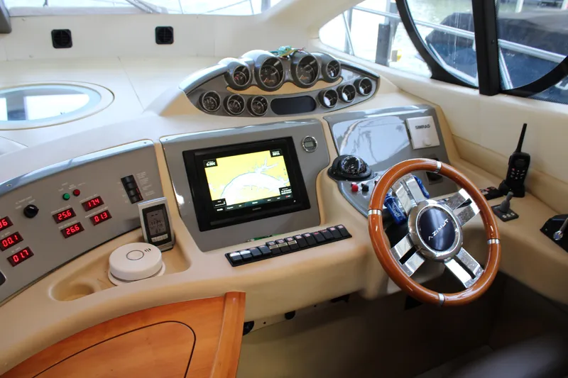  Yacht Photos Pics Helm of 2006 Azimut 50 yacht with navigation instruments and wooden steering wheel.