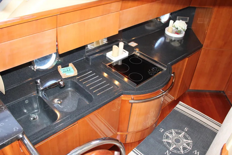  Yacht Photos Pics Luxurious kitchen in a 2006 Azimut 50 yacht with sleek countertops and modern appliances.
