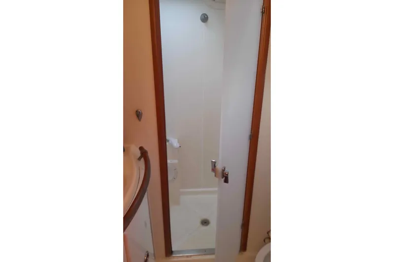 Sillage Yacht Photos Pics Shower area inside a 2002 Lagoon 380 catamaran, featuring a compact design.