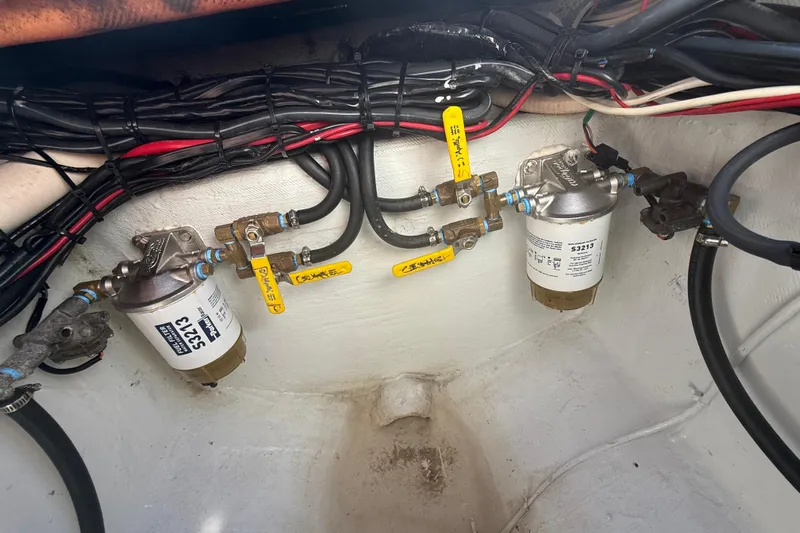  Yacht Photos Pics Fuel filters and valves in a 2003 Contender 27 Open boat engine compartment.
