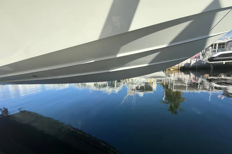  Yacht Photos Pics 2003 Contender 27 Open boat hull reflecting on calm water.