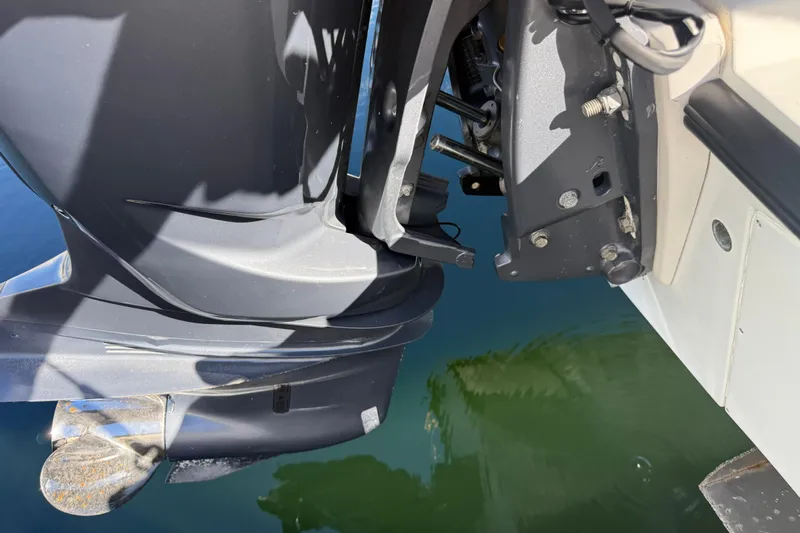  Yacht Photos Pics Close-up of a 2003 Contender 27 Open boat motor and propeller in water.