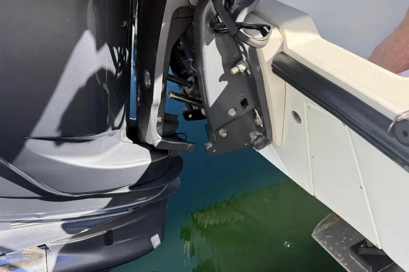  Yacht Photos Pics 2003 Contender 27 Open boat engine and transom detail by the water.