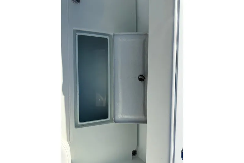  Yacht Photos Pics 2003 Contender 27 Open boat storage compartment, open lid, white interior.