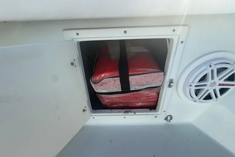  Yacht Photos Pics Storage compartment on a 2003 Contender 27 Open boat with red life jackets.