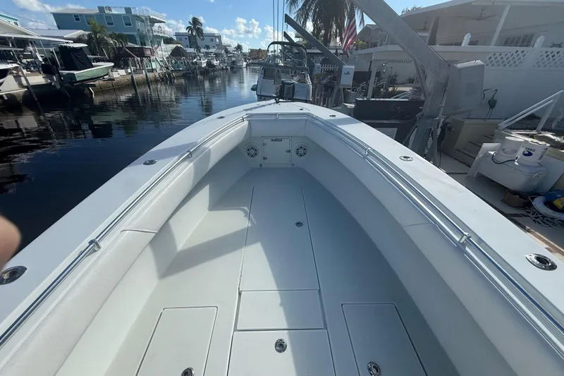  Yacht Photos Pics 2003 Contender 27 Open boat docked in a scenic canal setting.