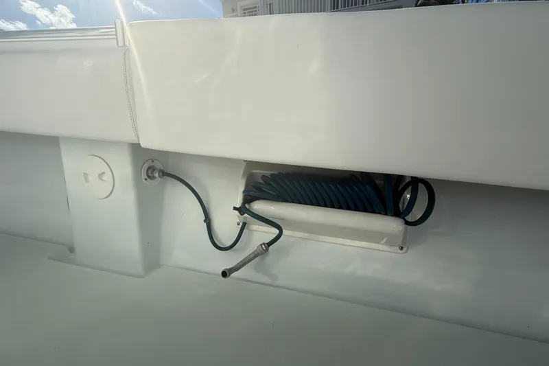  Yacht Photos Pics 2003 Contender 27 Open boat with coiled hose storage in the deck.