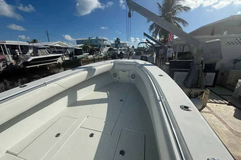  Yacht Photos Pics 2003 Contender 27 Open boat docked, sunny day, palm trees, and waterfront view.