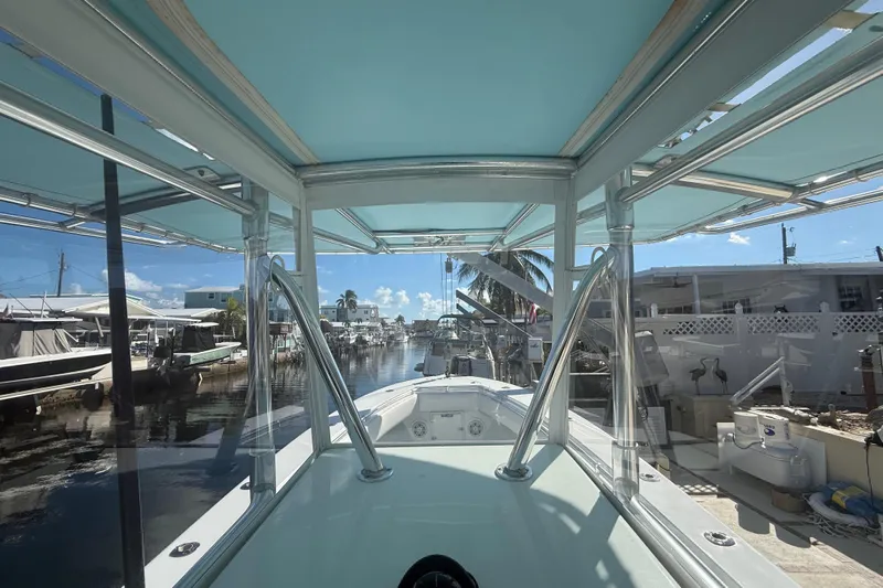  Yacht Photos Pics 2003 Contender 27 Open boat docked in a sunny marina, featuring a sleek design.