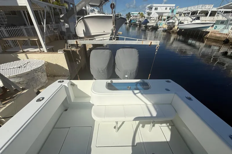  Yacht Photos Pics 2003 Contender 27 Open boat docked in a sunny marina, showcasing spacious deck layout.