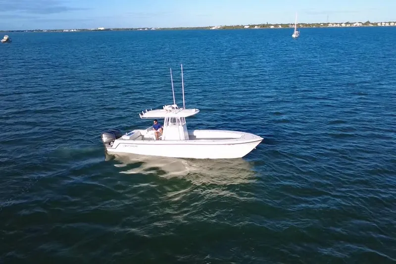  Yacht Photos Pics 2003 Contender 27 Open boat cruising on calm blue waters.