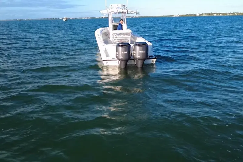  Yacht Photos Pics 2003 Contender 27 Open boat with dual engines on open water.