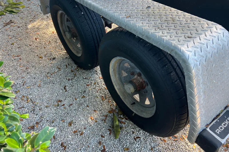  Yacht Photos Pics Trailer wheels on gravel, 2003 Contender 27 Open boat trailer.