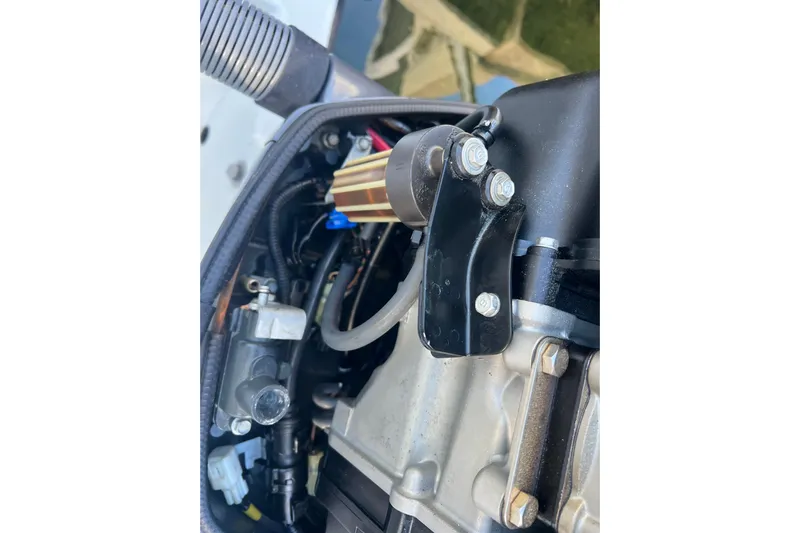  Yacht Photos Pics Close-up of a 2003 Contender 27 Open boat engine component.