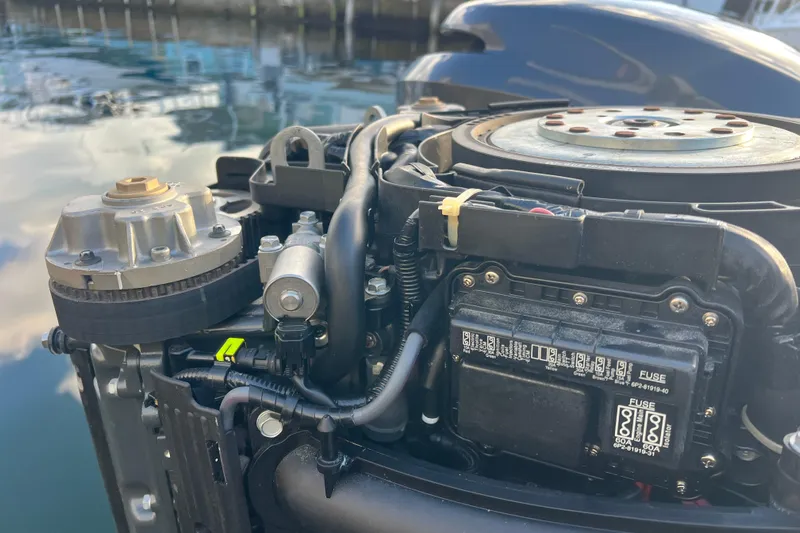 Yacht Photos Pics Close-up of a 2003 Contender 27 Open boat engine, showing detailed components.