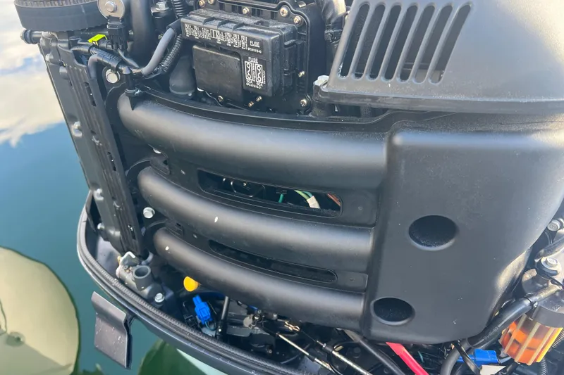  Yacht Photos Pics Close-up of a 2003 Contender 27 Open boat engine, showcasing mechanical details.