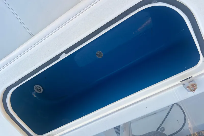  Yacht Photos Pics Open storage compartment on 2003 Contender 27 Open boat, featuring a blue interior.