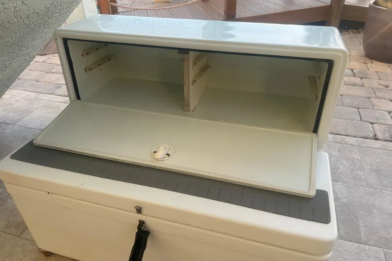  Yacht Photos Pics Open storage compartment on a 2003 Contender 27 Open boat, showing interior shelves.