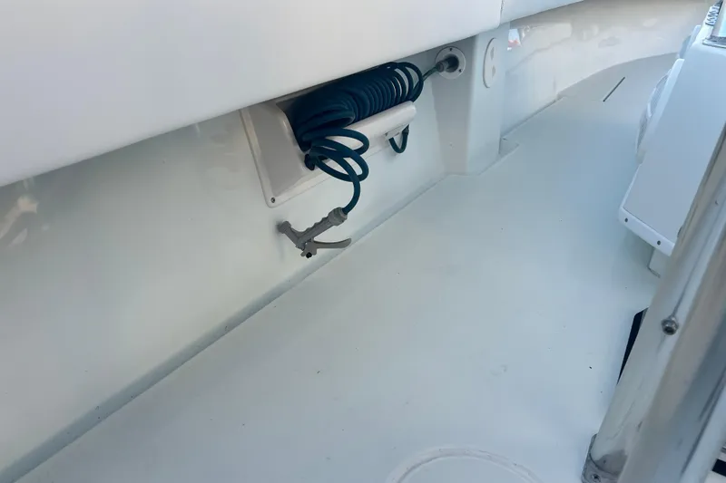  Yacht Photos Pics 2003 Contender 27 Open boat interior with coiled hose and clean white deck.