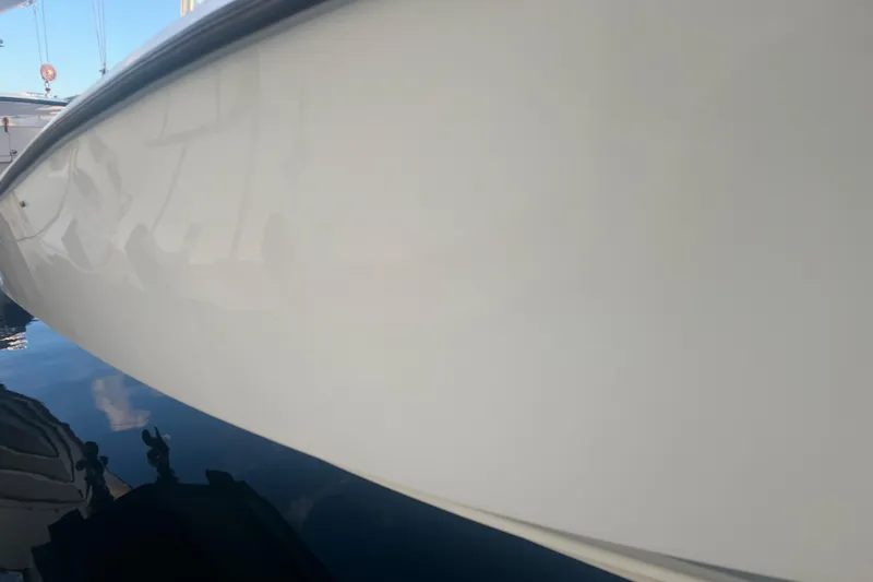  Yacht Photos Pics 2003 Contender 27 Open boat hull reflecting on water, showcasing sleek design.