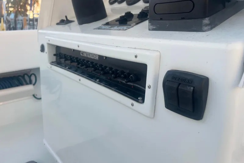  Yacht Photos Pics Control panel of a 2003 Contender 27 Open boat, featuring switches and buttons.
