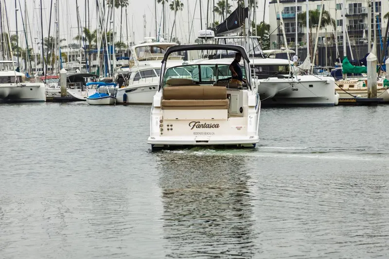 Fantasea Yacht Photos Pics 2014 Regal 32 Express boat in marina, surrounded by other vessels.