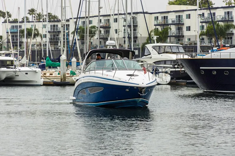 Fantasea Yacht Photos Pics 2014 Regal 32 Express boat navigating marina with yachts and waterfront buildings.