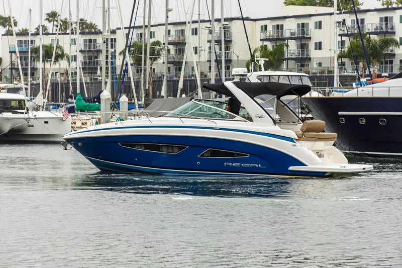 Fantasea Yacht Photos Pics 2014 Regal 32 Express boat docked in a marina, surrounded by other vessels.