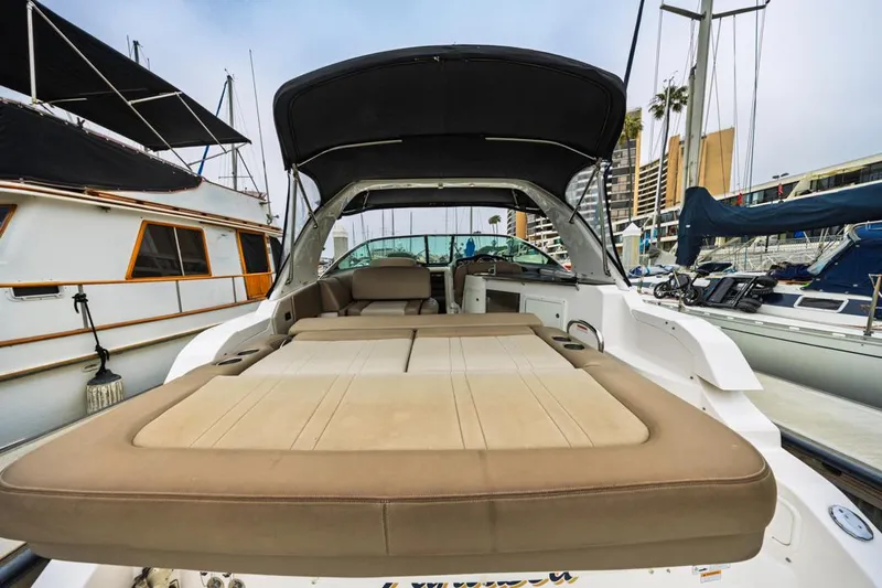 Fantasea Yacht Photos Pics 2014 Regal 32 Express boat with spacious deck and canopy in marina setting.