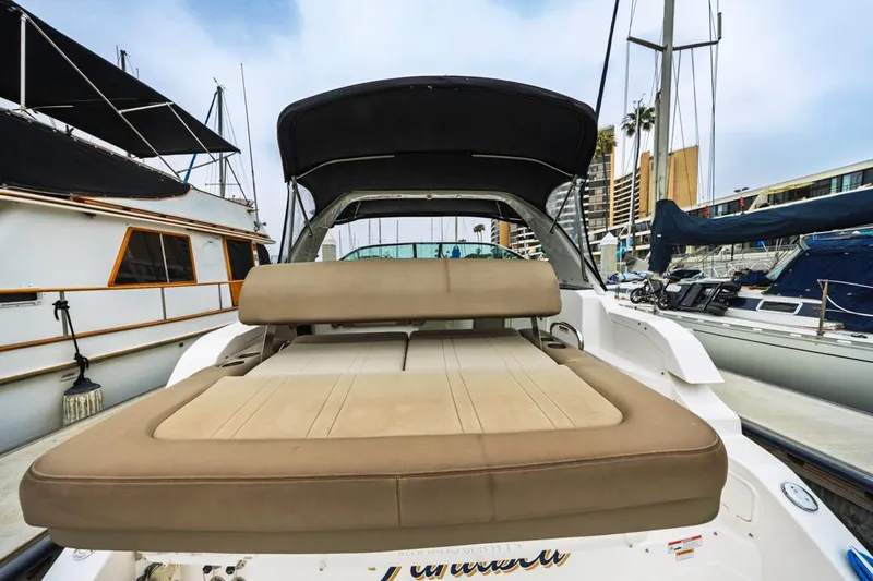 Fantasea Yacht Photos Pics 2014 Regal 32 Express boat with cushioned seating in a marina setting.