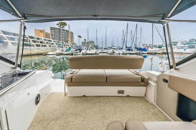Fantasea Yacht Photos Pics 2014 Regal 32 Express boat interior with marina view, featuring comfortable seating and canopy.