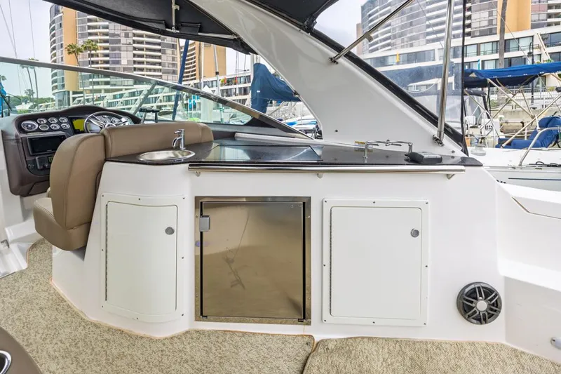 Fantasea Yacht Photos Pics 2014 Regal 32 Express yacht interior with kitchenette and helm, docked in marina.