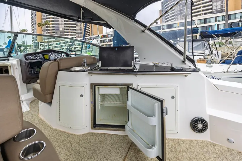 Fantasea Yacht Photos Pics 2014 Regal 32 Express boat interior with open fridge and seating area.