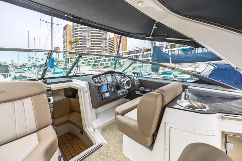 Fantasea Yacht Photos Pics 2014 Regal 32 Express boat interior with helm, seating, and marina view.