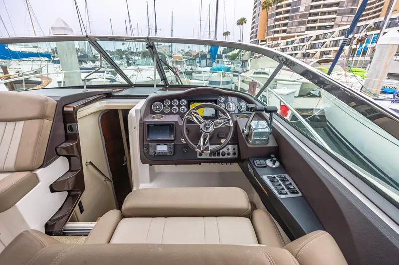 Fantasea Yacht Photos Pics Interior of 2014 Regal 32 Express boat with helm and dashboard controls.