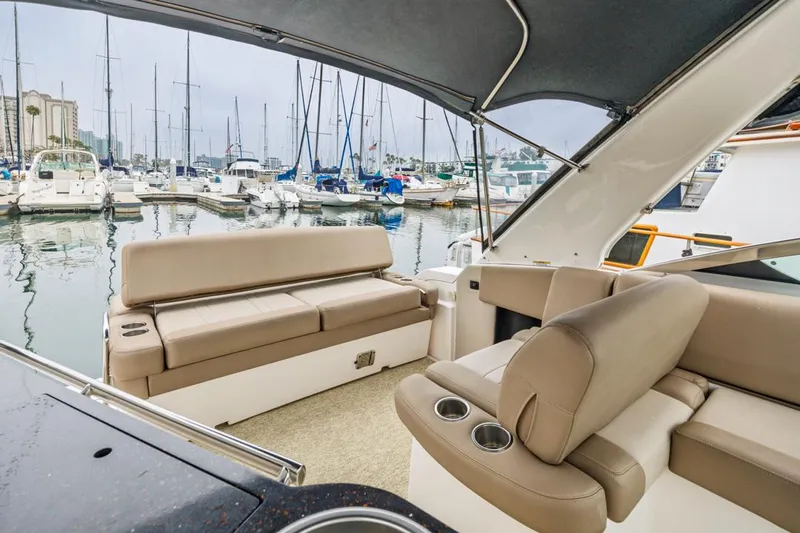 Fantasea Yacht Photos Pics 2014 Regal 32 Express boat interior with beige seating, docked at a marina.