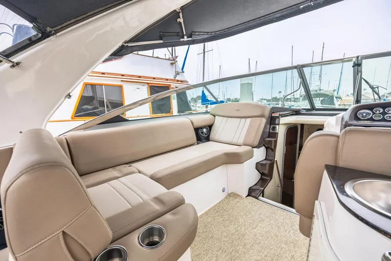 Fantasea Yacht Photos Pics 2014 Regal 32 Express boat interior with beige seating and modern dashboard.