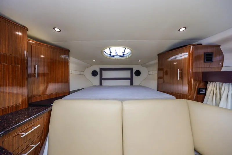 Fantasea Yacht Photos Pics Interior of 2014 Regal 32 Express yacht with wood cabinets and circular skylight.