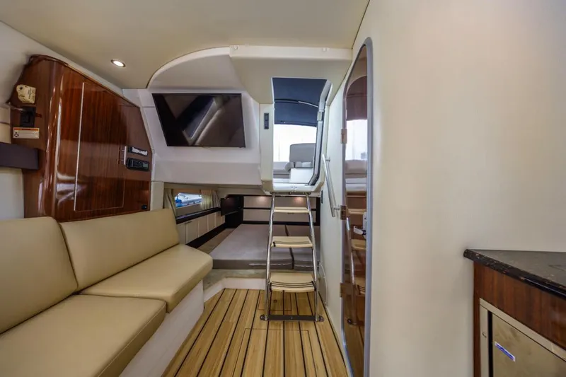 Fantasea Yacht Photos Pics Interior of 2014 Regal 32 Express yacht with modern seating and wooden flooring.