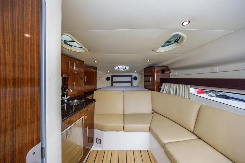 Fantasea Yacht Photos Pics Interior of 2014 Regal 32 Express yacht with beige seating and wooden cabinetry.