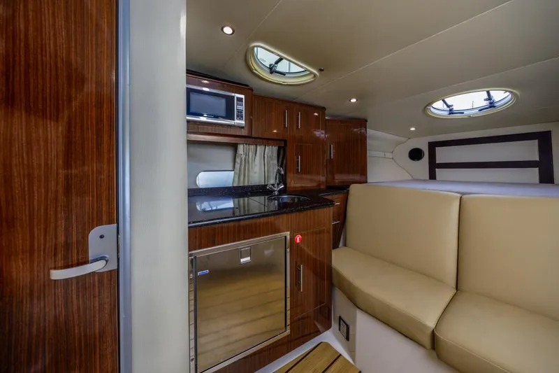 Fantasea Yacht Photos Pics 2014 Regal 32 Express interior with kitchenette, seating, and modern amenities.