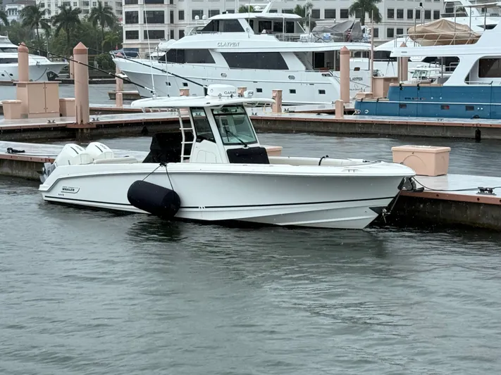  Yacht Photos Pics 2022 Boston Whaler 330 Outrage docked at marina, surrounded by yachts.