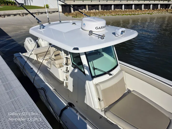  Yacht Photos Pics 2022 Boston Whaler 330 Outrage docked, featuring Garmin equipment and spacious seating.