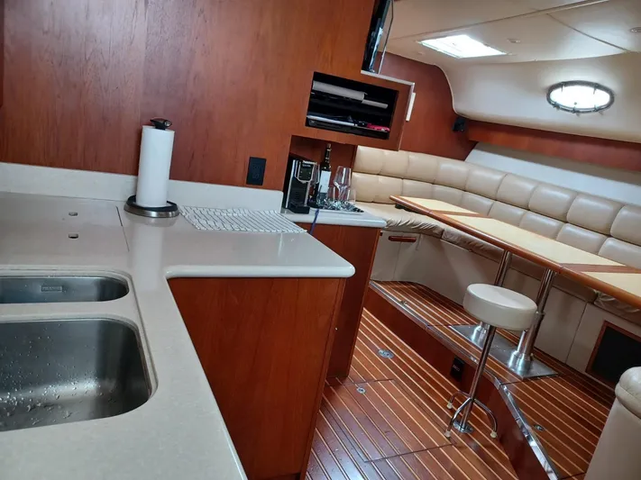  Yacht Photos Pics Luxurious interior of a 2002 Tiara Yachts 4000 Express with modern kitchen and seating area.