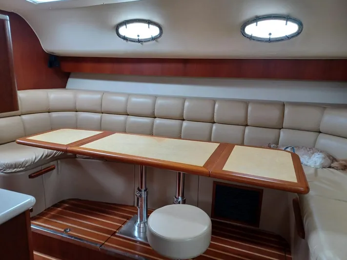  Yacht Photos Pics 2002 Tiara Yachts 4000 Express interior with beige seating and wooden table.