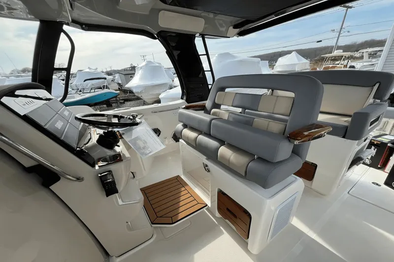  Yacht Photos Pics Interior of 2025 Boston Whaler 350 Realm boat, featuring modern helm and seating.